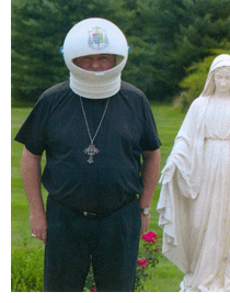 Archbishop John J. Myers with Space Helmet and Statue